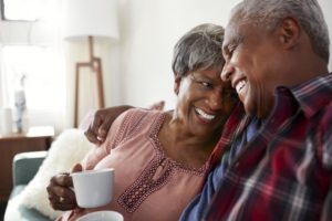 couple smiling and drinking coffee