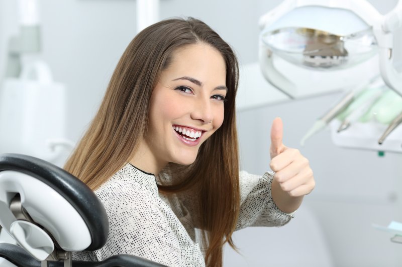 woman smiling sitting dentist chair